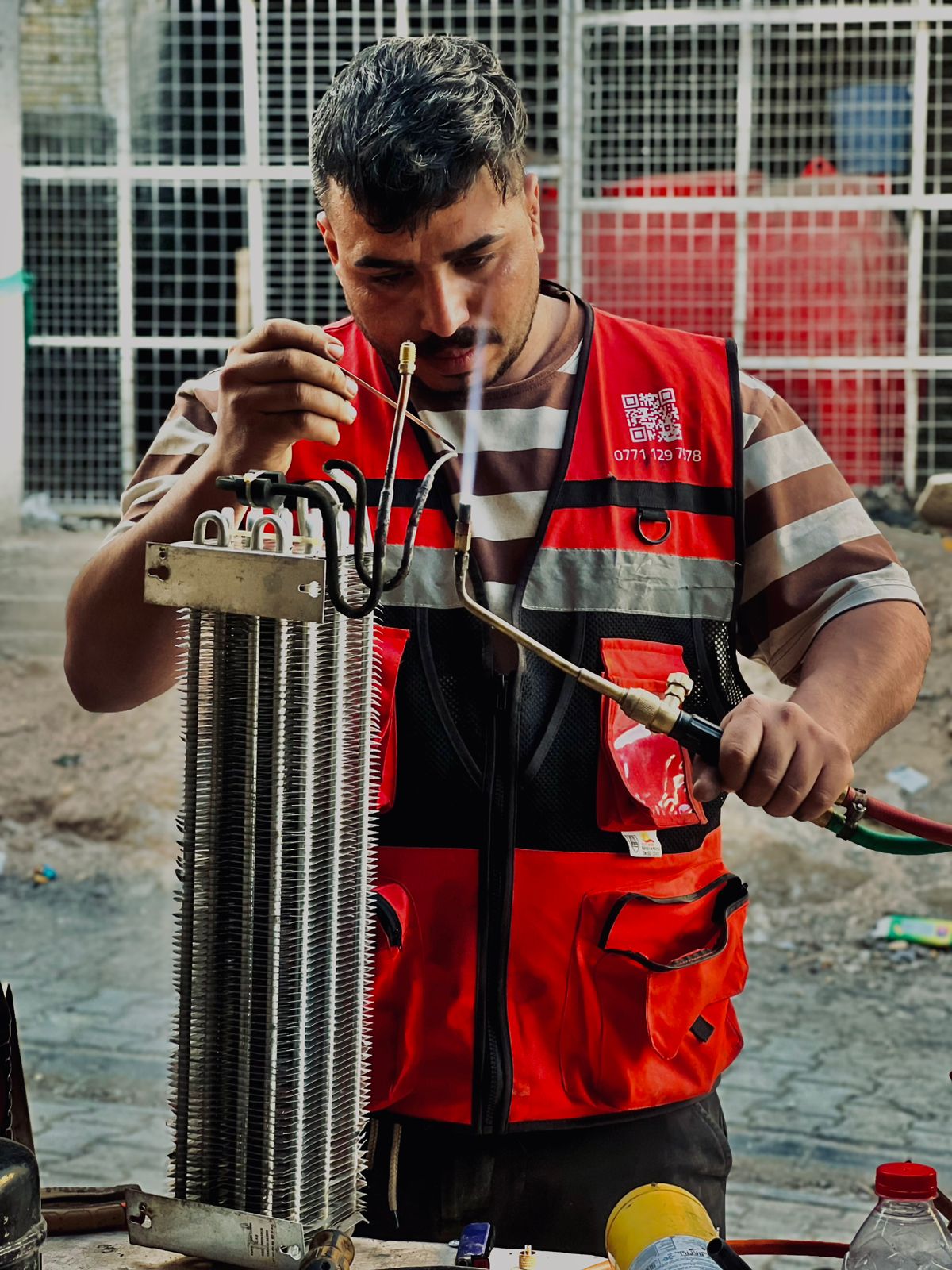 Khadamaty technician repairing an air conditioner in Iraq